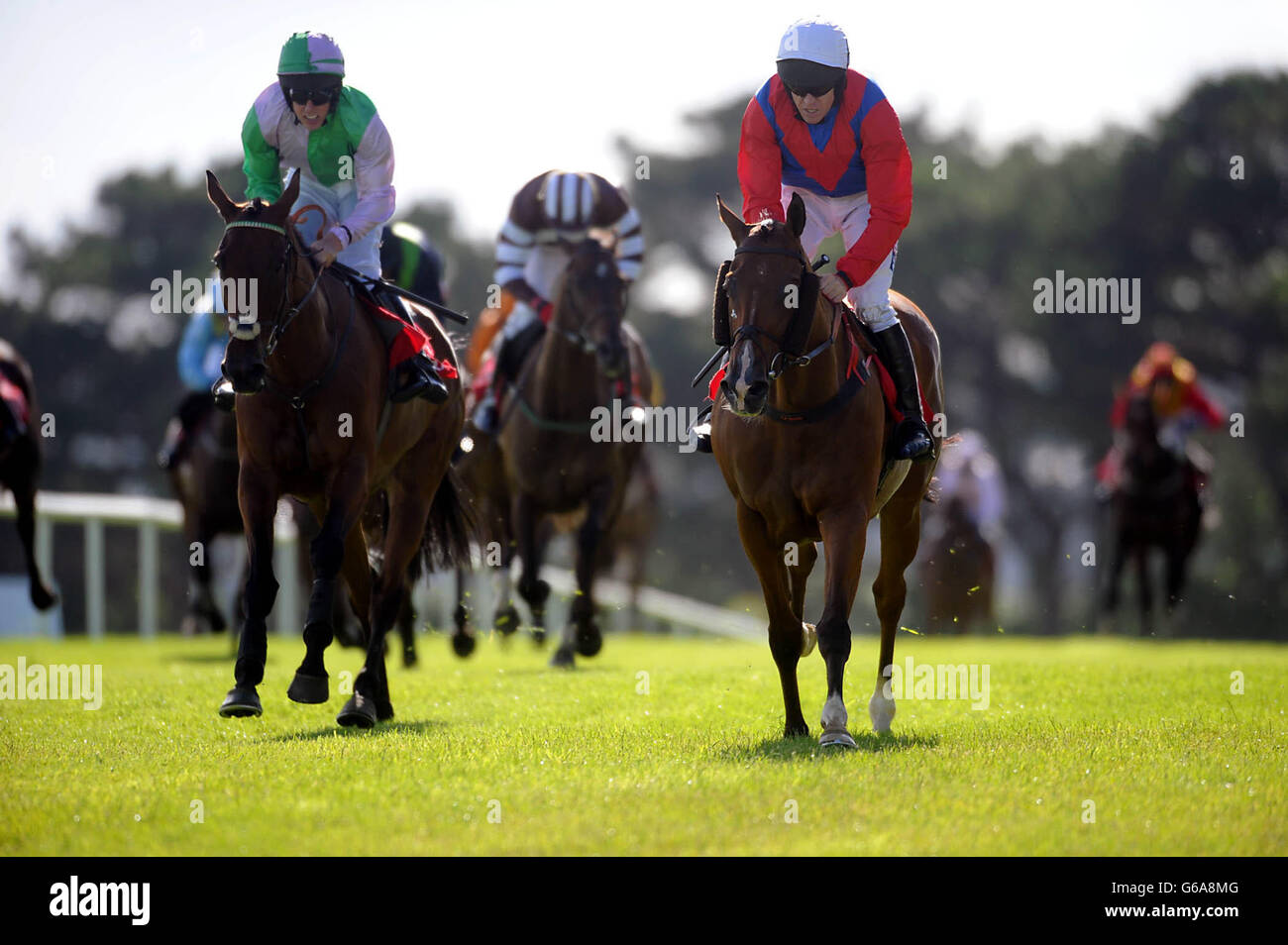 Jockey Barry Geraghty rides Aladdins Cave (right) to victory in the Sean 'The Budgie' Burgess Memorial Handicap Hurdle during day one of the 2013 Galway Summer Festival at Galway Racecourse, Ballybrit. Stock Photo
