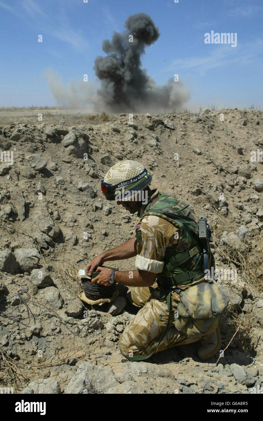 Engineers from The 1st Battalion The Parachute Regiment dispose of unexploded bomblets found in the desert near their base in the southern Iraqi oilfields. * The region is littered with unexploded ordnance including anti-tank and anti-personnel mines which are detonated in place for the safety of the coalition troops and local civilians. Stock Photo