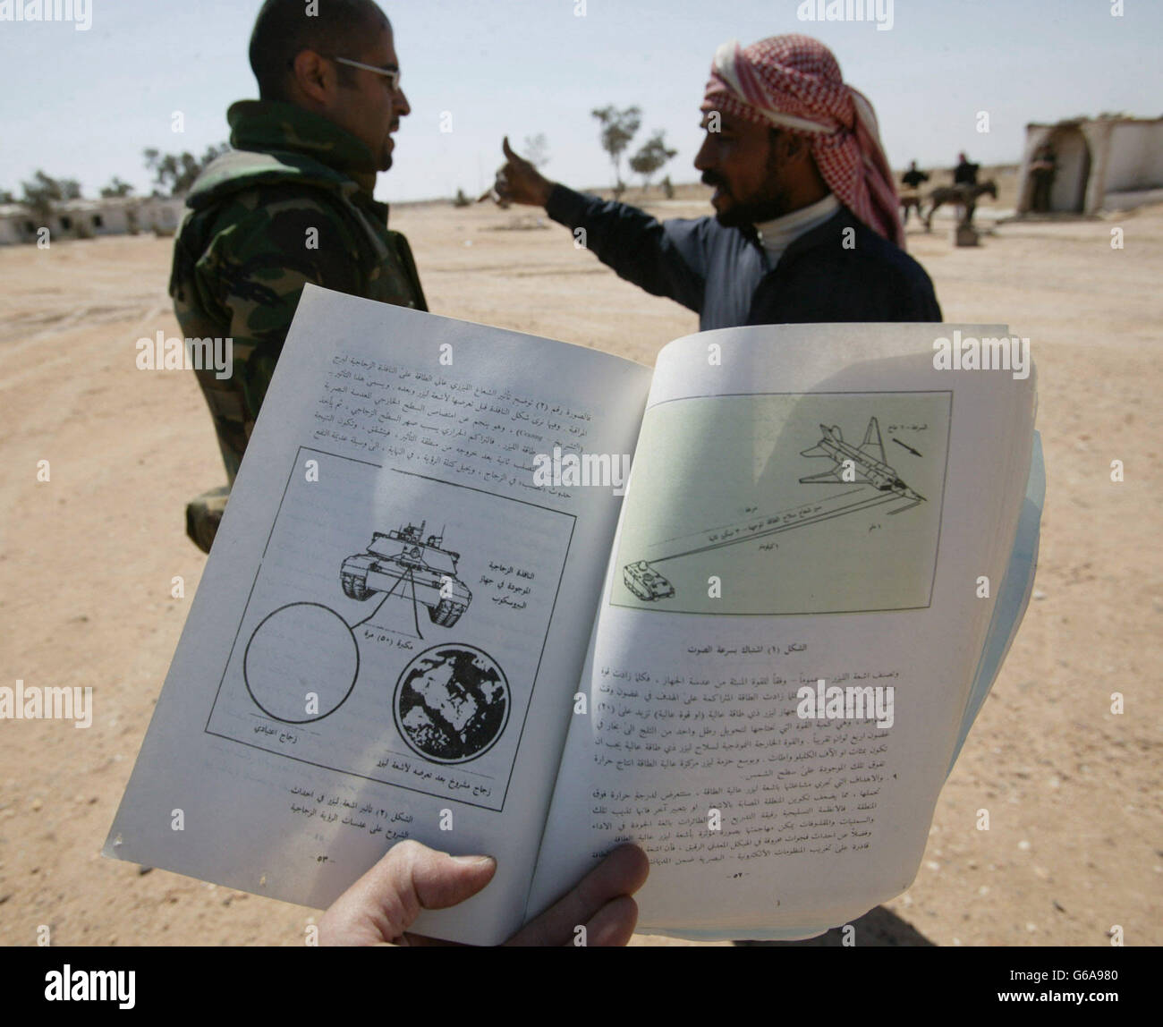 A Kuwaiti interpreter speaks to an Iraqi civilian whilst accompanying REME Captain Ken Jolley on a 'Hearts and Minds' mission. Dan Chung / Guardian / MOD Pool. Stock Photo