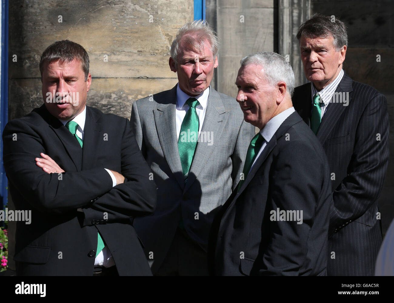 Former players (left to right) Paul Kane, Alex Cropley, Eric Stevenson and John Fraser at the funeral of former Hibernian and Scotland football player, Lawrie Reilly, at St Andrew's and St George's West Church in Edinburgh. Hundreds of fans turned out to pay their respects as the cortege passed the East Stand of Hibernian's Easter Road stadium. Stock Photo