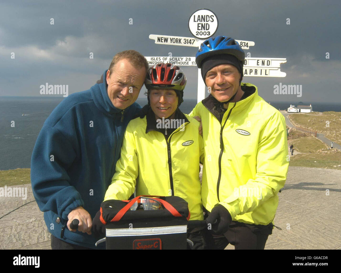 Cancer sufferer Jane Tomlinson celebrates her arrival at Lands End, Cornwall, with her brother Luke Goward and husband Mike (L) , after completing the tandem charity bike ride from John O'Groates. Stock Photo