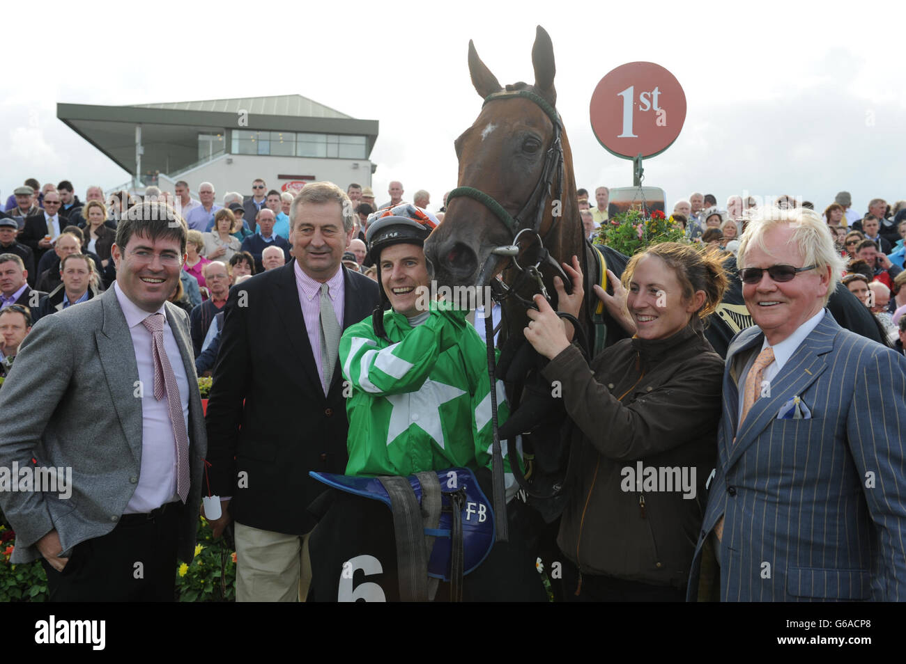 Racing connections celebrate after jockey Fran Berry rode Curley Bill to victory in the Guinness Handicap during day five of the 2013 Galway Summer Festival at Galway Racecourse, Ballybrit, Ireland. Stock Photo