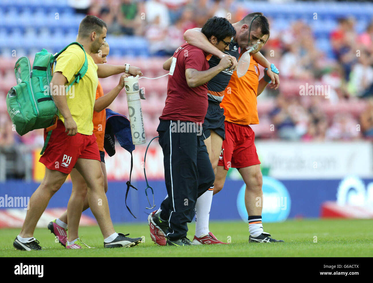 Hull KR's Jordan Cox is helped from the field during the Super League match at the DW Stadium, Wigan. Stock Photo