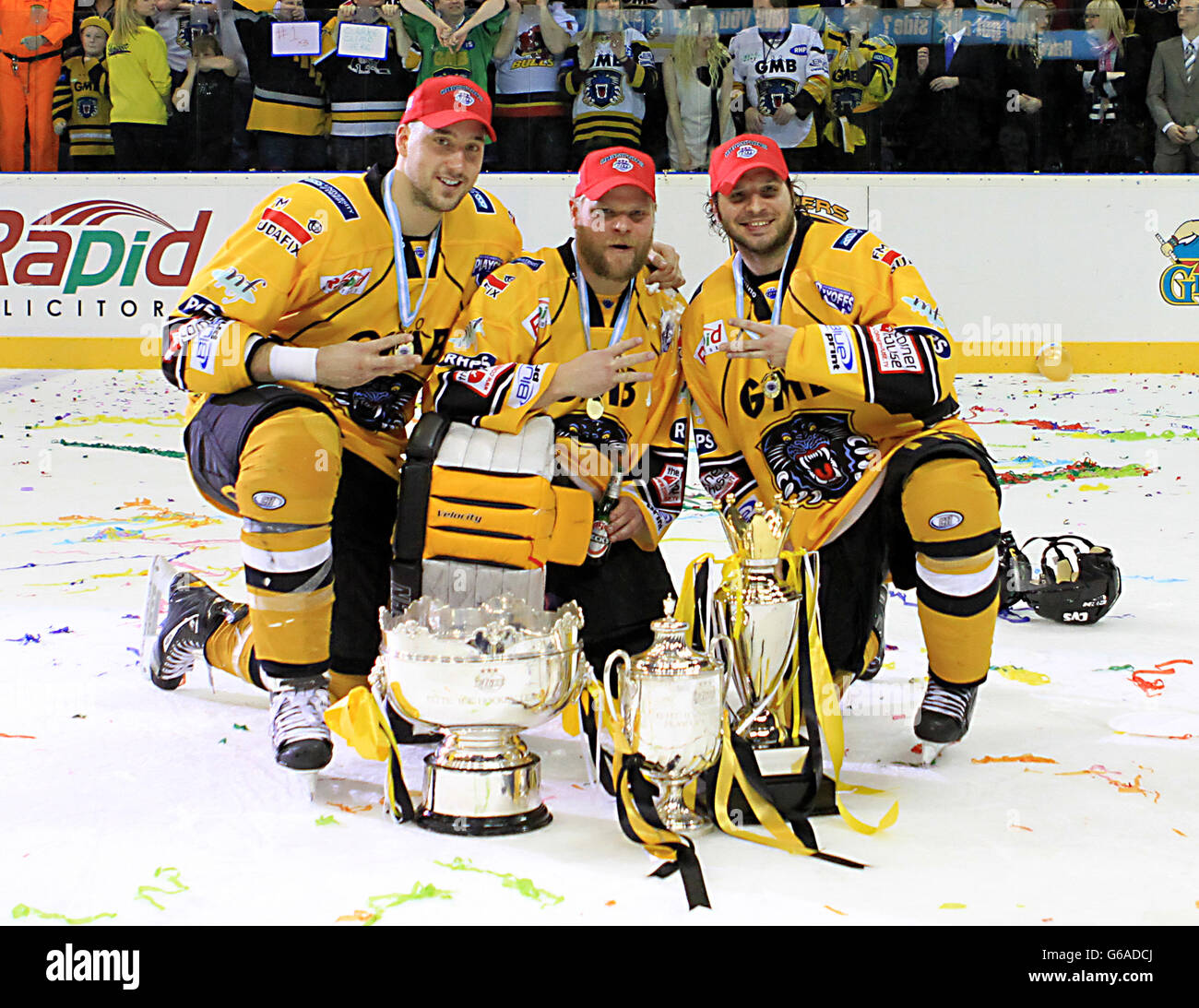 Nottingham Panthers' Guillaume Lepine (left) and Craig Kowalski (centre) and Eric Werner pose with the Elite League Trophy, Elite League Play-Off Trophy and Elite League Challenge Cup Stock Photo