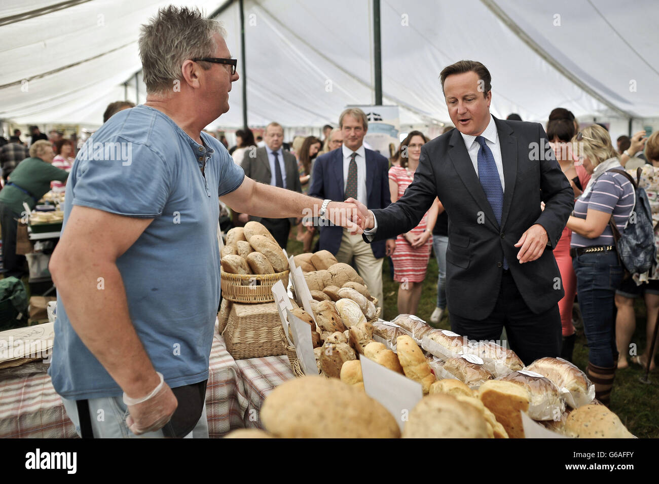 Prime Minister David Cameron chats with stall holders during a visit to the North Devon Agricultural Show, at Barton Farm in Umberleigh, Devon. Stock Photo