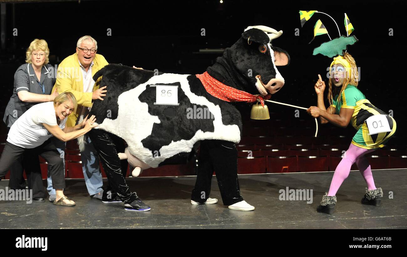 (Left to right) St Joseph's Hospice nurse Carolyne Barber, Susie McKenna, Creative Director at the Hackney Empire, Christopher Biggins, a panto cow and Hackney Empire's Puss in Boots panto dame KAT B, during a photocall at Hackney Empire in London, to launch the Dame Dash 2013 charity run. Stock Photo