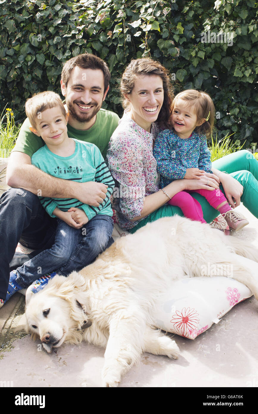 Family with young children and family dog, portrait Stock Photo