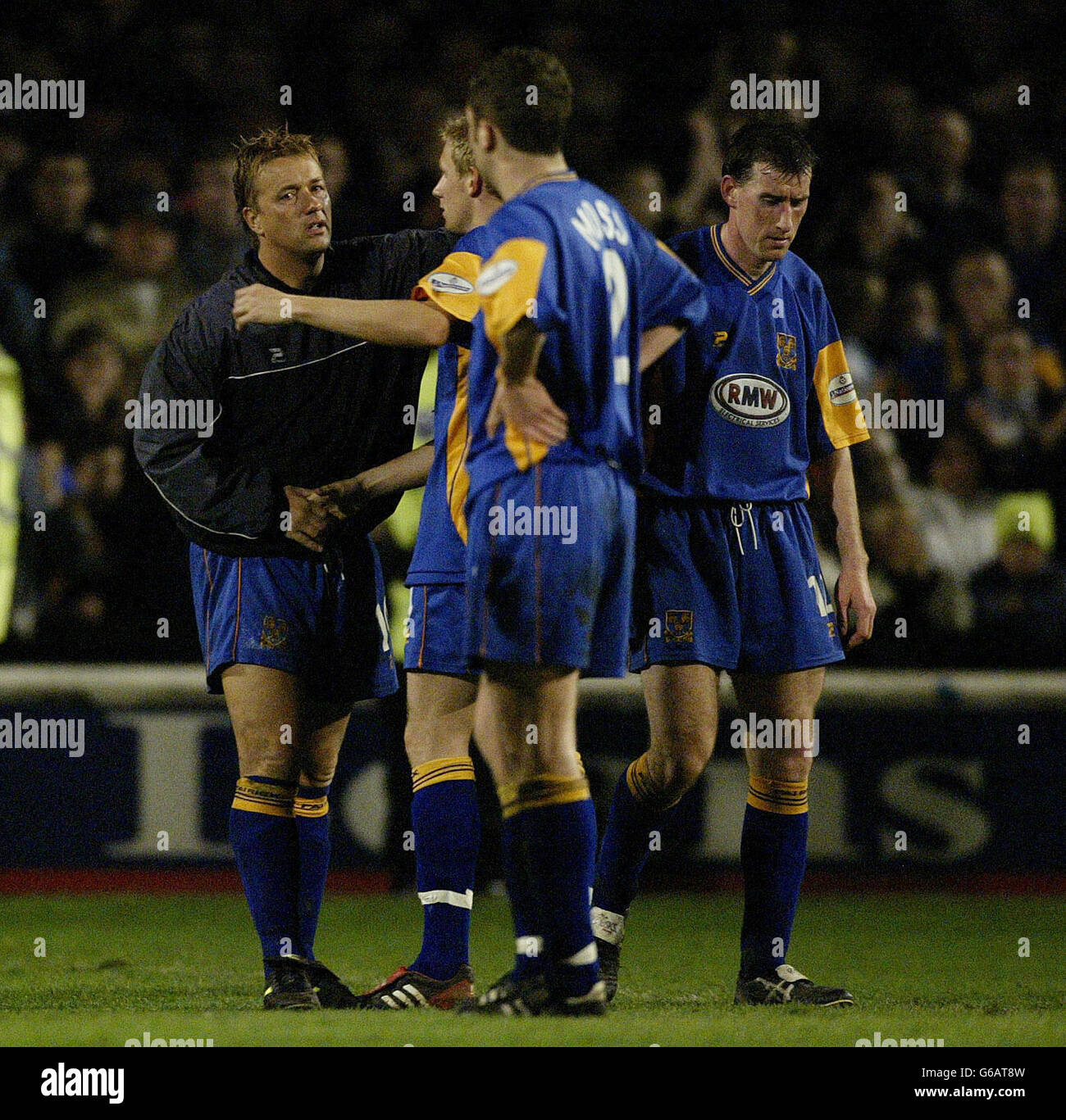 Dejected Shrewsbury Town captain Nigel Jemson (left) hugs Jamie Tolly (centre) as Peter Wilding looks sadly to the ground (right) after they lost 3 - 2 against Carlisle United and were relegated into Confrence football, during the Nationwide Divison Three game at Gay Meadow, Shrewsbury. NO UNOFFICIAL CLUB WEBSITE USE. Stock Photo