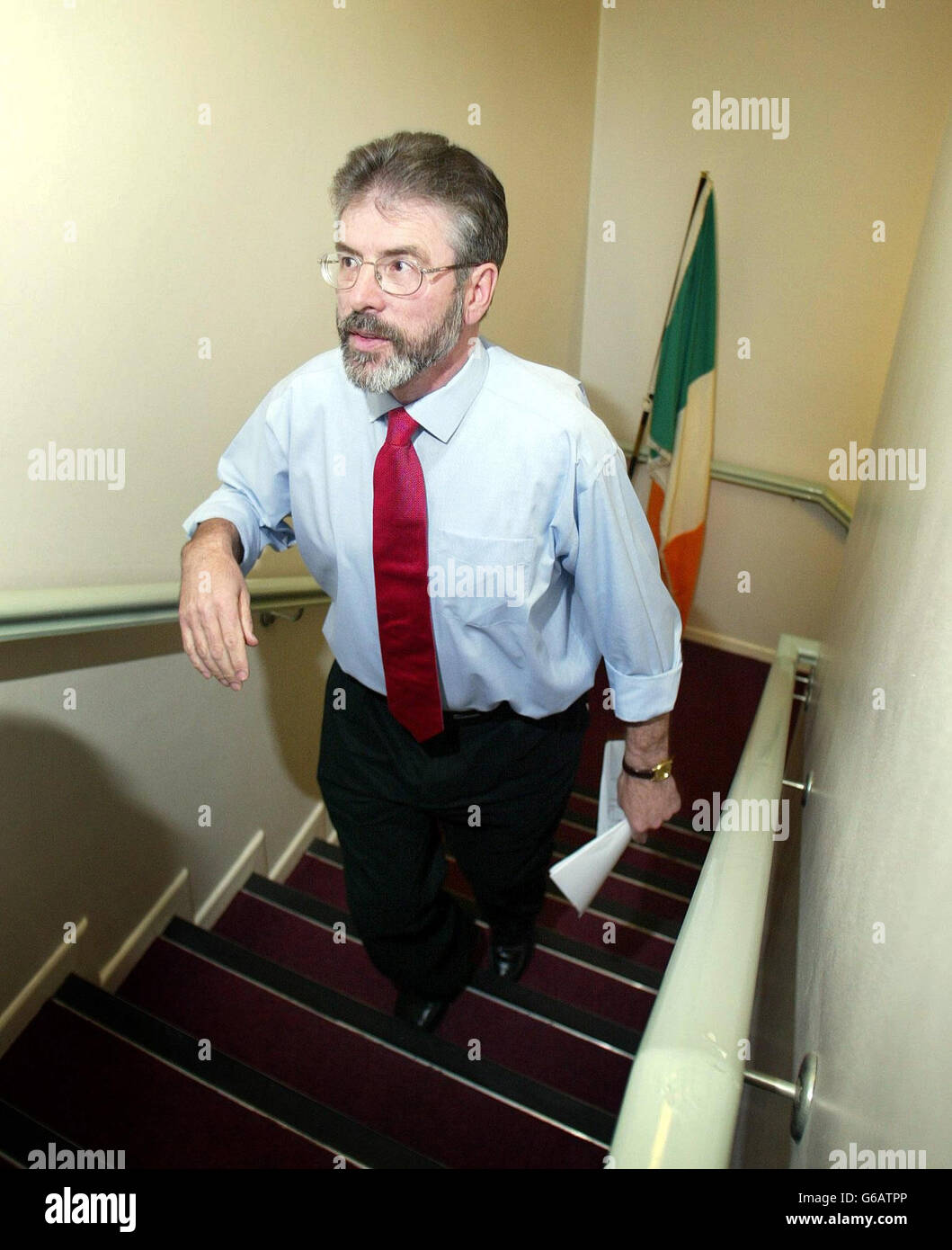 Sinn Fein President Gerry Adams arrives to speak at a press conference in Belfast, during the speak he said that,The IRA will not in any way undermine the peace process or the Good Friday Agreement. *..In a statement which was being billed as the definitive position from republicans on the IRA`s future, Mr Adams said: ``The IRA leadership makes it clear in its statement that it is determined that its activities will be consistent with its resolve to see the complete and final closure of the conflict.` Stock Photo