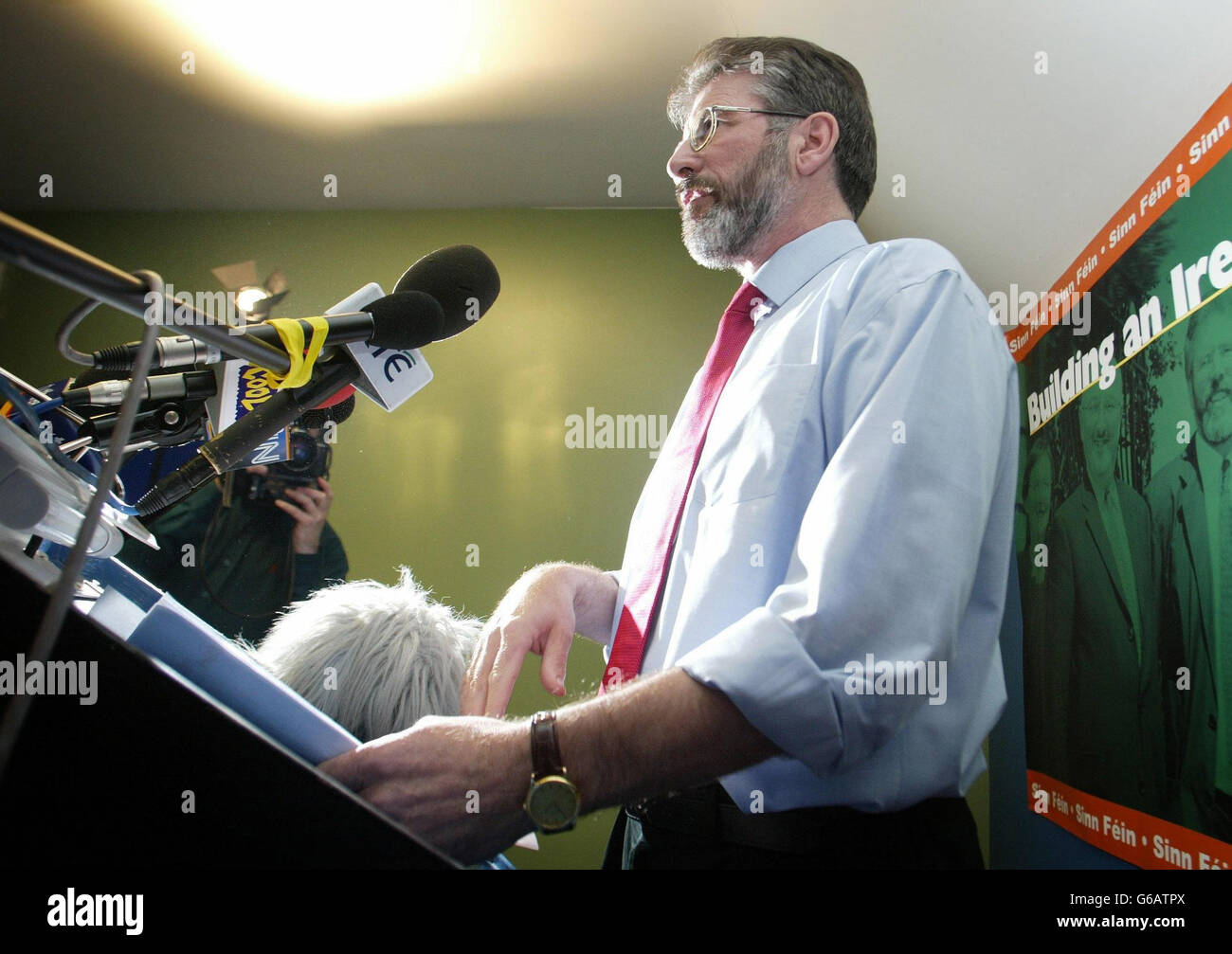 Sinn Fein President Gerry Adams arrives to speak at a press conference in Belfast, during the speak he said that,The IRA will not in any way undermine the peace process or the Good Friday Agreement. *..In a statement which was being billed as the definitive position from republicans on the IRA`s future, Mr Adams said: ``The IRA leadership makes it clear in its statement that it is determined that its activities will be consistent with its resolve to see the complete and final closure of the conflict.` Stock Photo