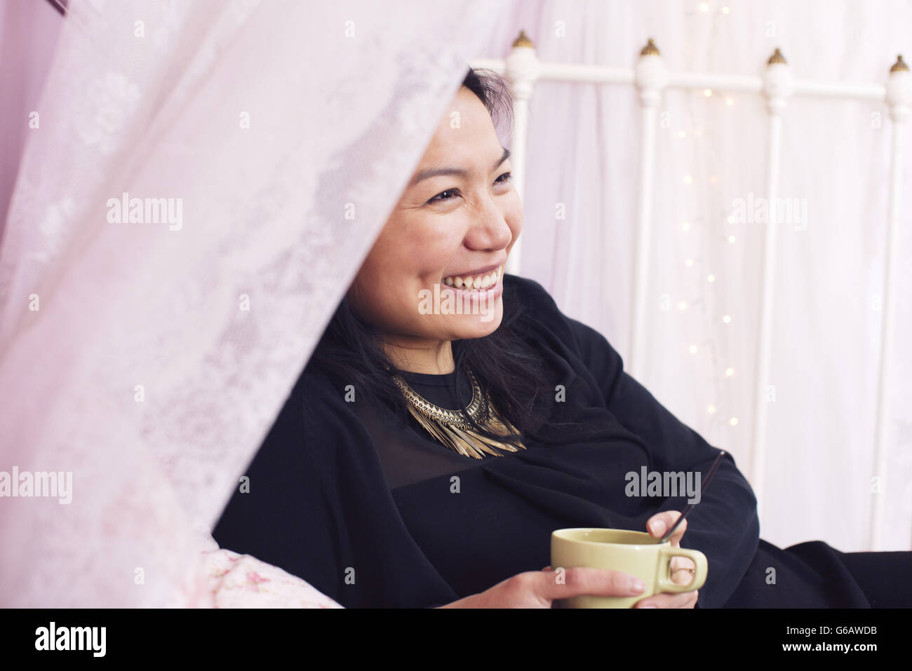 Woman relaxing with cup of coffee Stock Photo - Alamy