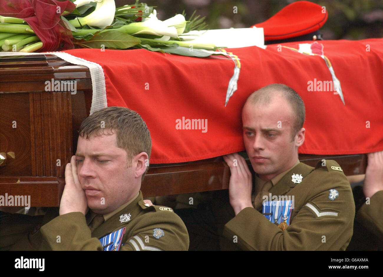 Two pallbearers carry the coffin of Corporal Stephen Allbutt, member of the Queen's Royal Lancers, on route to Holy Trinity Church for the service. * They are both members of the 35-year-old's regiment and together with four other colleagues carried the coffin inside the church. The married soldier, who also served in the 1991 Gulf War was killed along with Trooper David Clarke, 19, from Stafford, when their Challenger 2 tank was shelled by another British tank during a firefight near Basra. Stock Photo