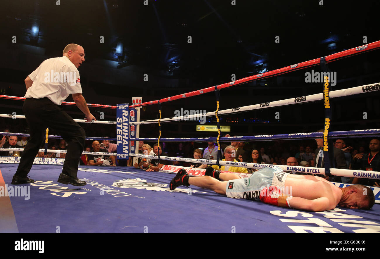 Gary Buckland's corner and the referee look on concerned after he is knocked out by Stephen Smith during their British Super-Featherweight Championship at the Motorpoint Arena, Cardiff. Stock Photo