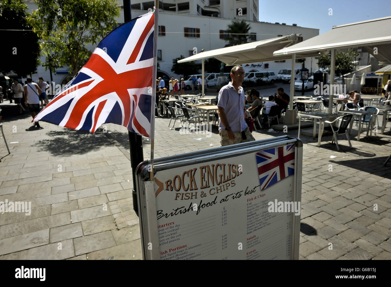 A Union flag flies above adverts for Rock English Fish & Chips in Casemates Square, Gibraltar