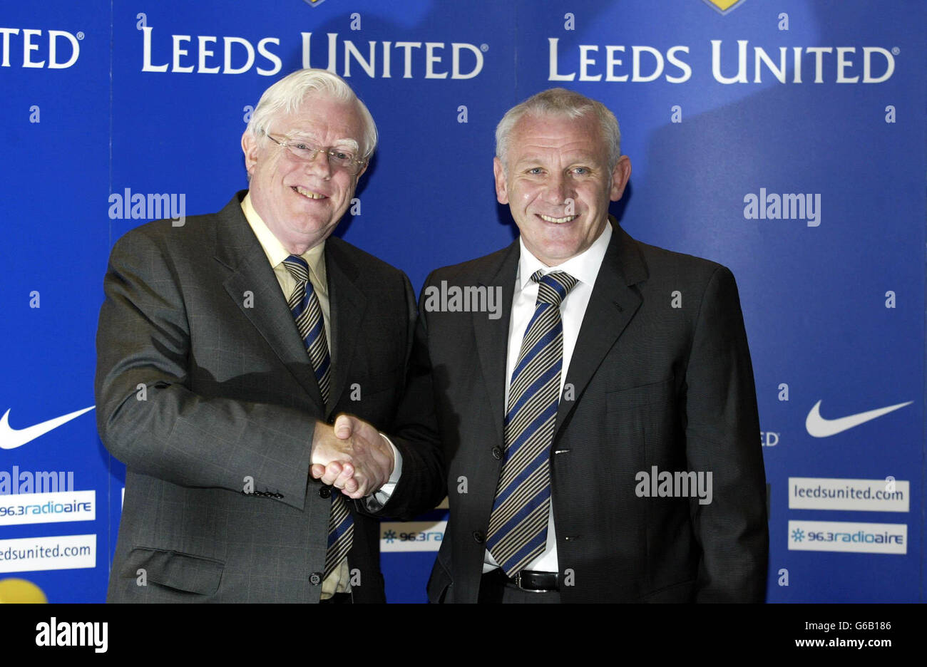 Leeds United's Chairman John McKenzie congratulates his new full-time manager Peter Reid (right) during a press conference at Elland Road, Leeds. Reid has been confirmed as Leeds United's third manager in a year. * Reid's reward for steering Leeds to Premiership safety in the role of caretaker manager is to become Terry Venables' permanent successor at Elland Road. Reid's arrival as caretaker with eight matches remaining was greeted with scepticism by some Leeds fans. But Leeds have taken 10 points from their seven games under Reid and fans and players alike seem to have warmed to him. . Stock Photo