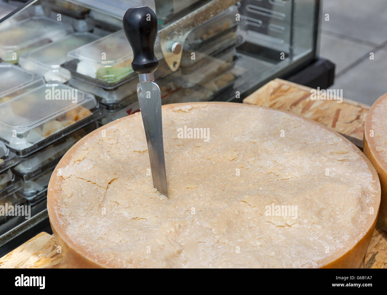 Parmesan cheese head with knife closeup. Stock Photo