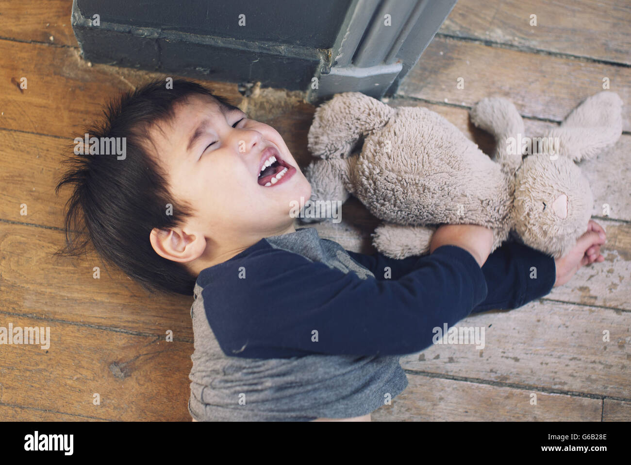 Little boy playing with stuffed toy Stock Photo