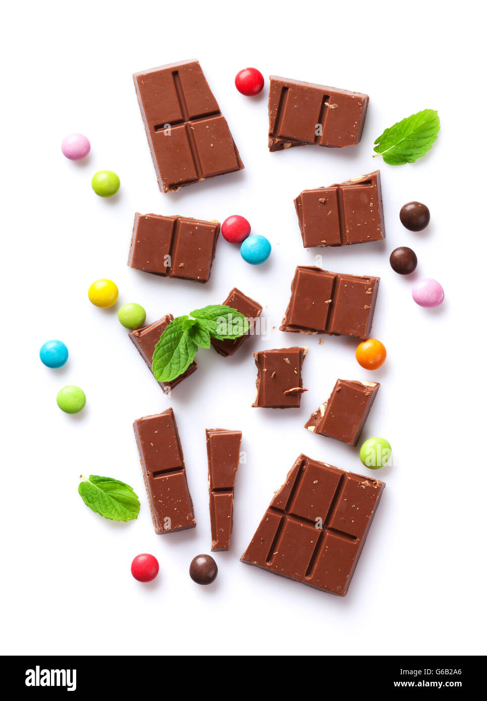 Broken chocolate bar and colorful candy sweets. Isolated on white background.  Top view Stock Photo - Alamy