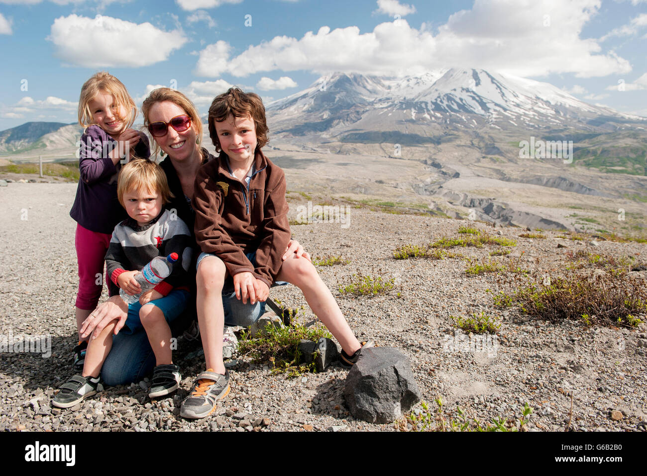 Mother and children posing in front of Mount St. Helens, Washington, USA Stock Photo