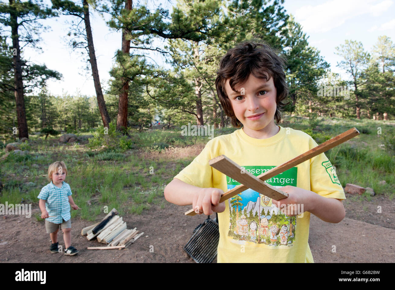 Boy preparing to build a campfire, portrait Stock Photo