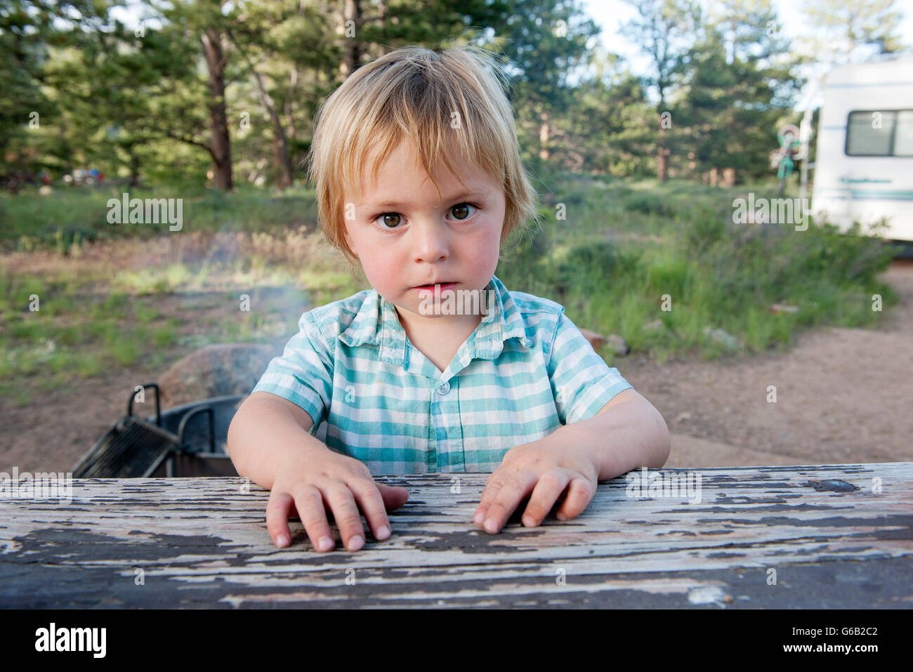 Little boy sitting at picnic table, portait Stock Photo