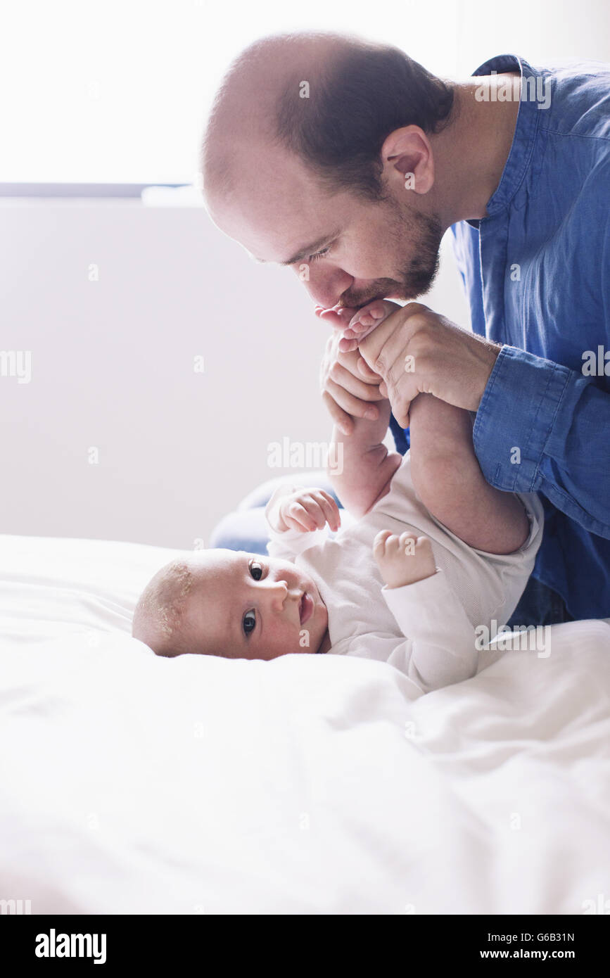 Father kissing infant son Stock Photo