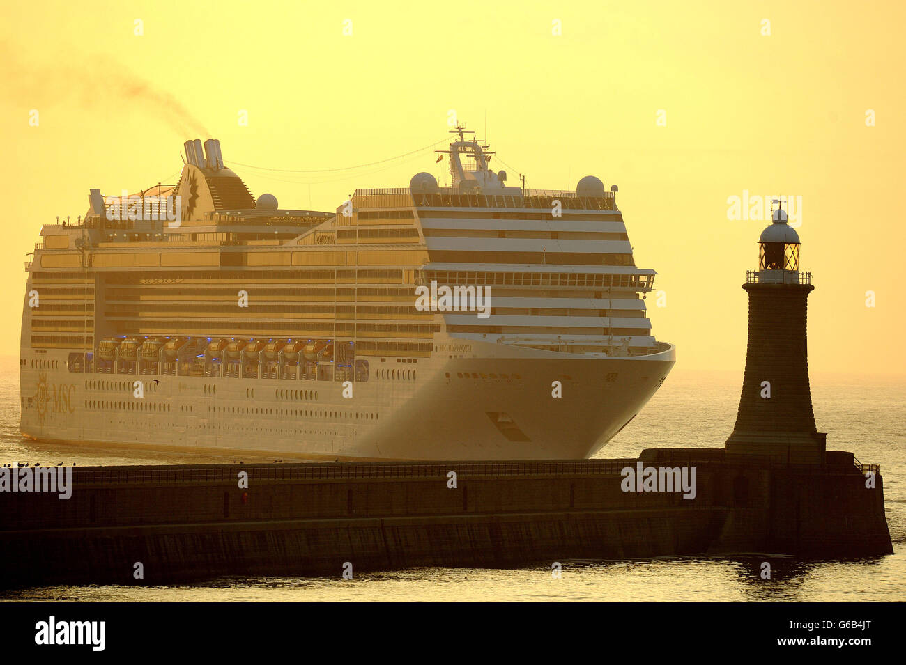 The MSC Magnifica cruise ship enters the mouth of River Tyne at sunrise. Stock Photo