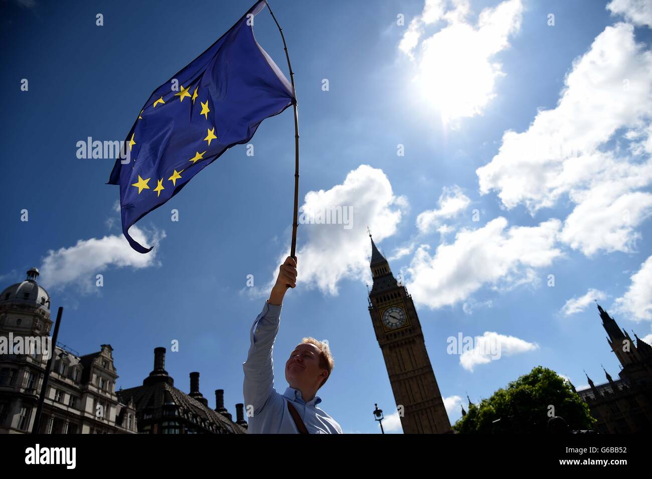Protester waves a European Union flag outside the houses of Parliament, Westminster on the day of the EU Referendum result Stock Photo