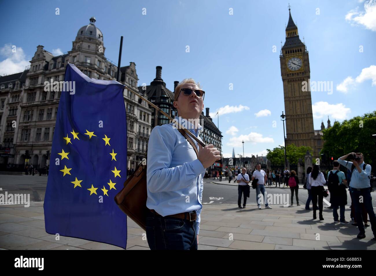 Protester waves a European Union flag outside the houses of Parliament, Westminster on the day of the EU Referendum result Stock Photo