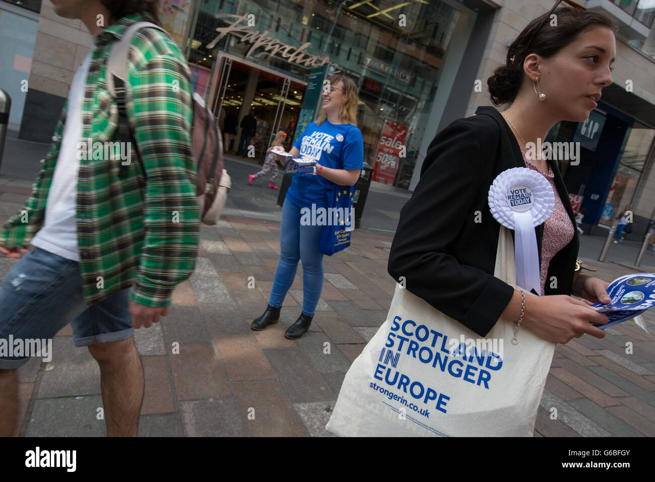 Glasgow, UK. 23rd June, 2016. Melodie Emre (in floral dress, glasses on head), a French language professor hands out leaflets for the 'Remain' campaign in Buchanan Street, as voting takes place on the United Kingdom's referendum on European Union membership, in Glasgow, Scotland, on 23 June 2016. Credit:  jeremy sutton-hibbert/Alamy Live News Stock Photo