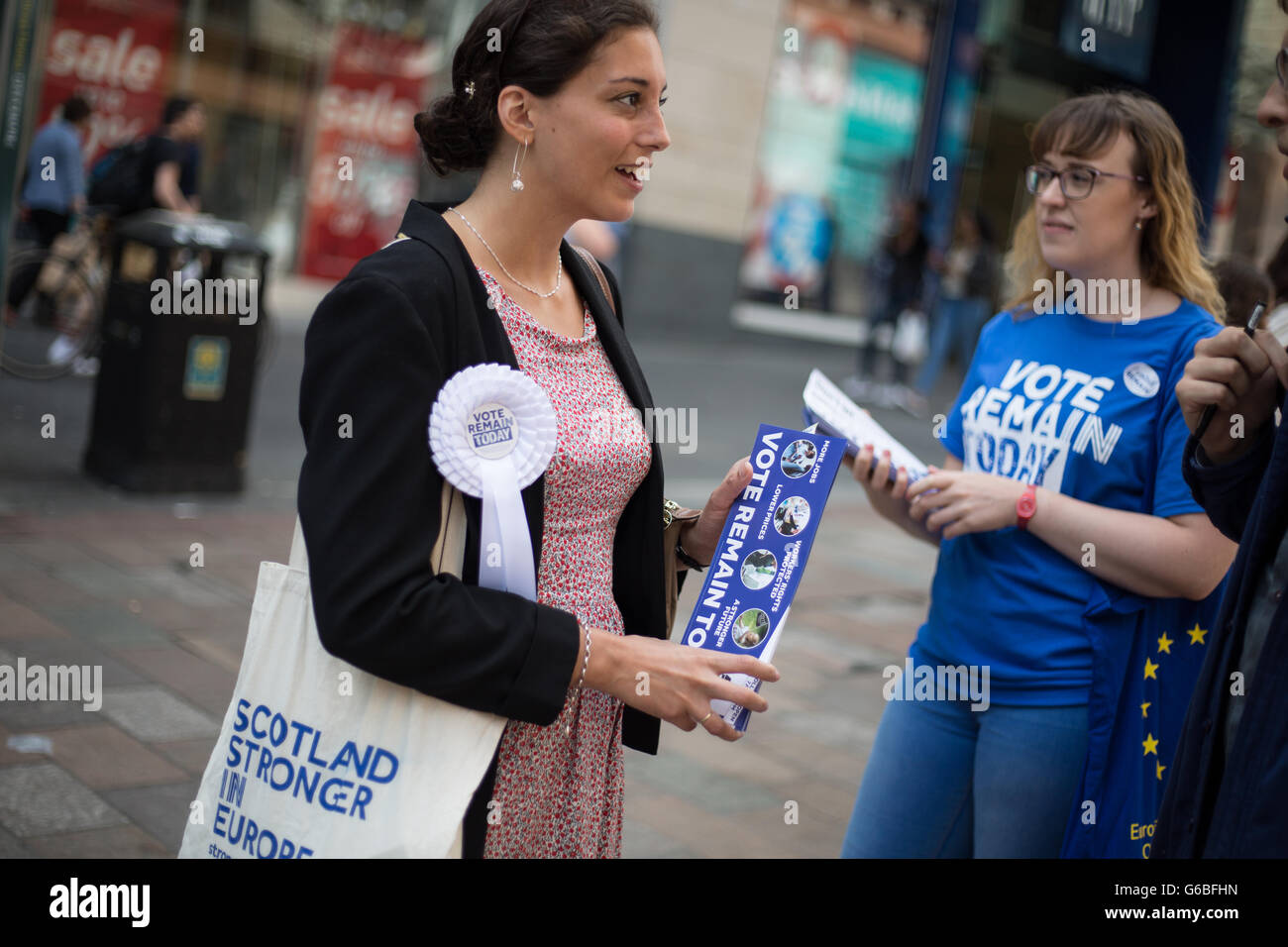 Glasgow, UK. 23rd June, 2016. Melodie Emre (in floral dress, glasses on head), a French language professor hands out leaflets for the 'Remain' campaign in Buchanan Street, as voting takes place on the United Kingdom's referendum on European Union membership, in Glasgow, Scotland, on 23 June 2016. Credit:  jeremy sutton-hibbert/Alamy Live News Stock Photo