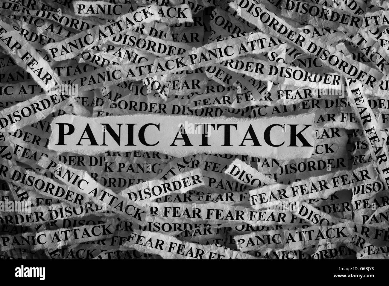 Panic Attack. Torn pieces of paper with the word Panic Attack. Concept Image. Black and White. Closeup. Stock Photo