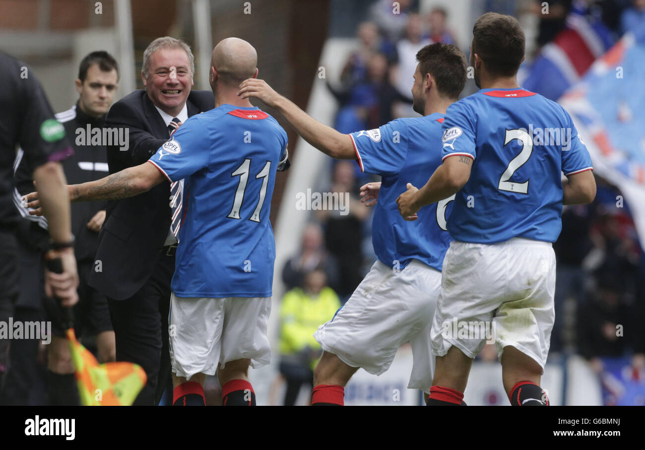 Rangers' Nicky Law (second left) celebrates his goal with manager Ally McCoist and team mates during the Scottish League Two match at Ibrox, Glasgow. Stock Photo