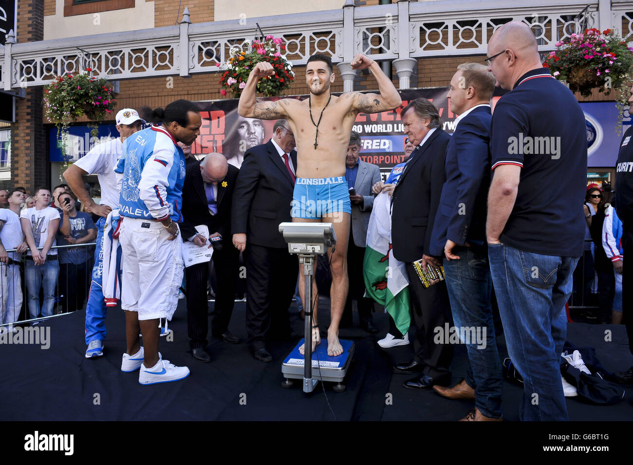 WBO World Light-Heavyweight Champion Nathan Cleverly flexes his muscles on the scales during the weigh in in Queen Street, Cardiff. Stock Photo
