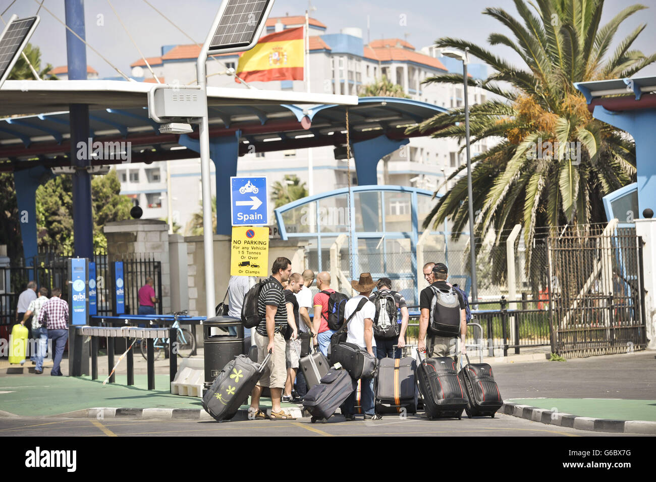 People are dropped off by bus on the Gibraltar side of the Spanish border as they prepare to cross as Spain has agreed to allow European Commission observers to its border with Gibraltar to assess the legality of checks on traffic that caused a diplomatic row with Britain. Stock Photo