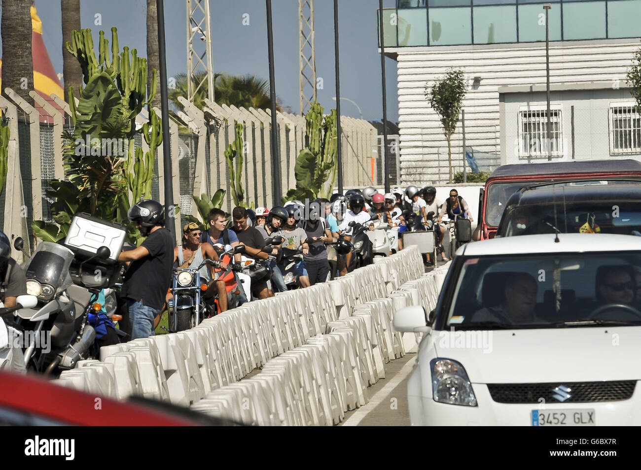 Motorcyclists and scooter riders sit in a separate lane traffic queues on the Gibraltar side of the Spanish border as Spain has agreed to allow European Commission observers to its border with Gibraltar to assess the legality of checks on traffic that caused a diplomatic row with Britain. Stock Photo