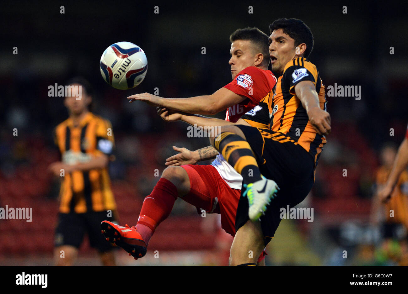 Hull's Joe Dudgeon and Leyton Orient's Dean Cox compete for possession during the Capital One Cup, Second Round match at the Matchroom Stadium, London. Stock Photo