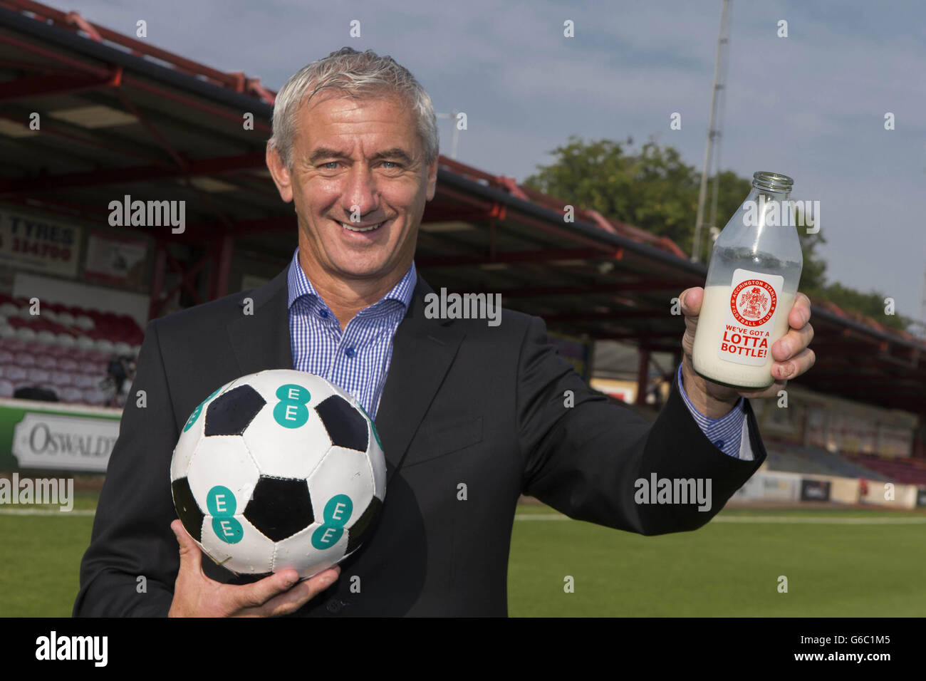 Football legend Ian Rush, who starred in the 1980s Milk Marketing Board advert that helped give Accrington Stanley FC national recognition, poses with a bottle of milk to mark the launch of the switch on of EE's superfast 4G network in Accrington, Lancashire - the 100th town to get 4G from EE. Stock Photo