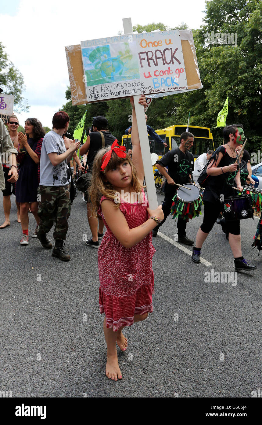 Environmental activists march through Balcombe, West Sussex, as anti fracking demonstrations continue at the Cuadrilla exploratory drilling site. Stock Photo