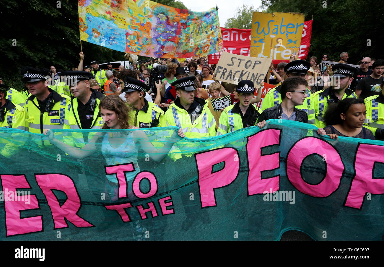 Environmental activists march through Balcombe, West Sussex, as anti fracking demonstrations continue at the Cuadrilla exploratory drilling site. Stock Photo