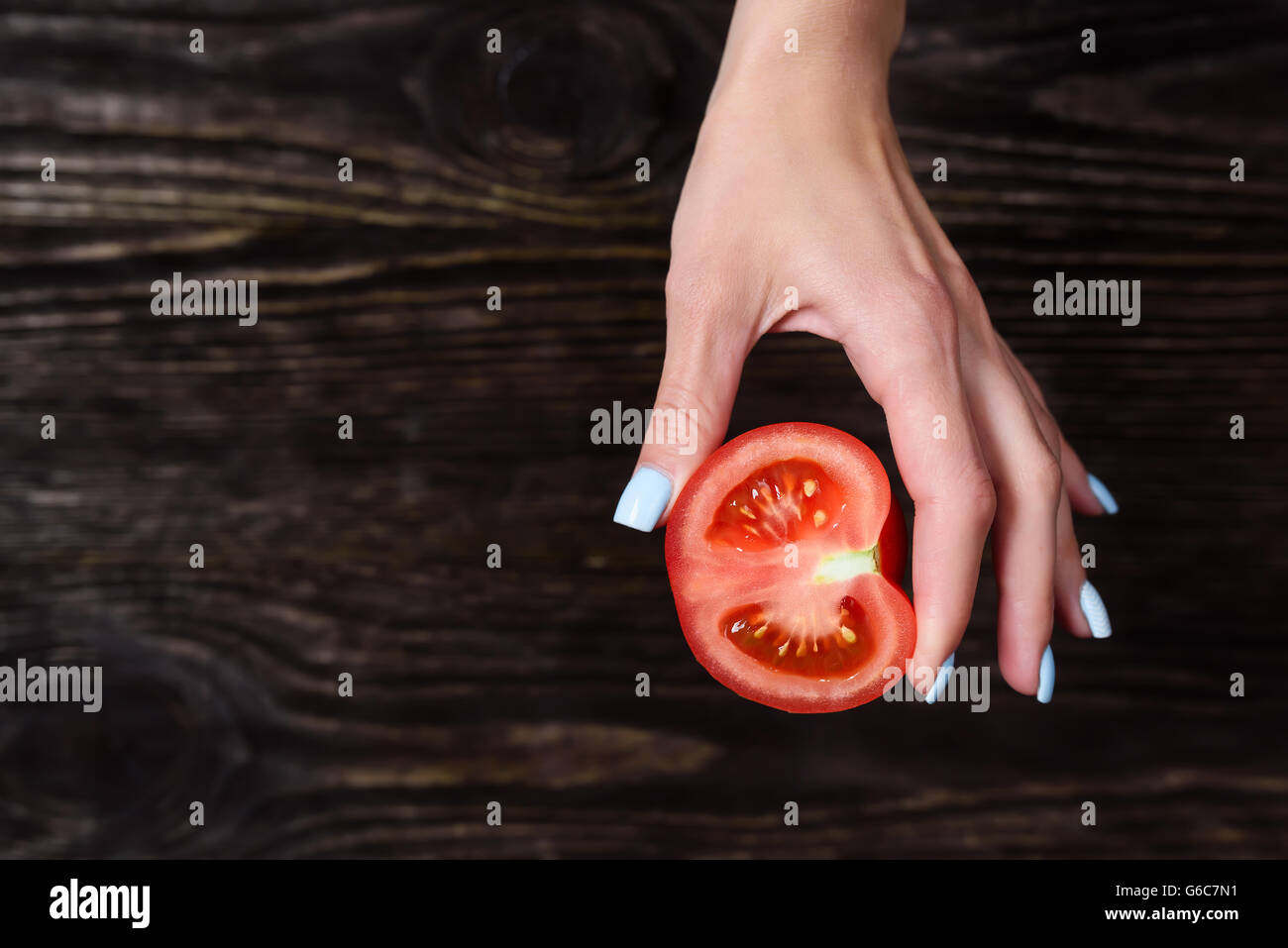 The girl in the hands holding a tomato Stock Photo - Alamy