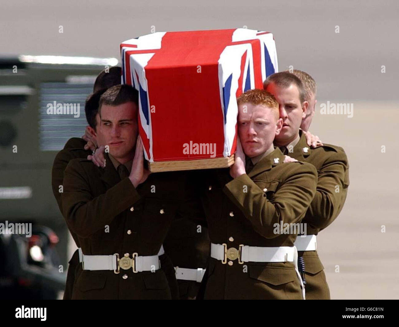 The body of Lance Corporal James McCue, 27, from Paisley, of 7 Air Assault Battalion, Royal Electrical & Mechanical Engineers, is carried from an RAF Hercules at RAF Brize Norton, during a repatriation service. * Corporal James McCue died on 30 April 2003 following an explosion in southern Iraq. Stock Photo
