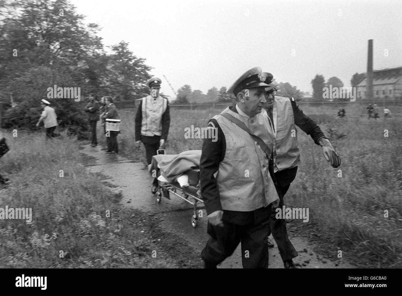 Ambulance men wheel away one of the victims from the scene of the BEA Trident crash. The Brussels-bound jet crashed minutes after take-off, killing 118 people on board. Stock Photo