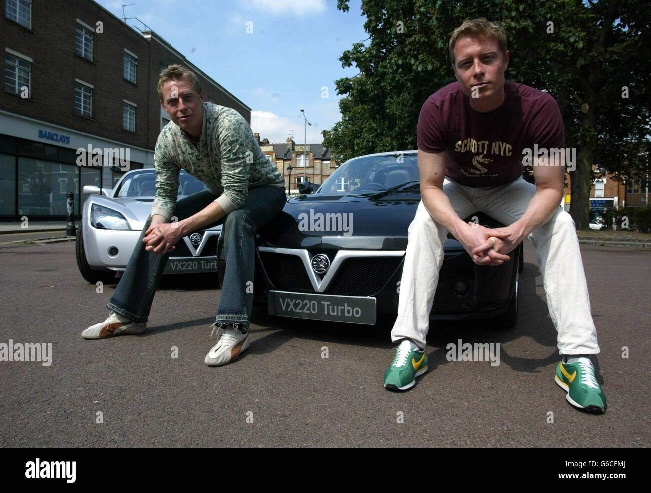 Picture released Thursday 29 May 2003 ot the Matrix Reloaded's 'Evil Twins', actors Neil & Adrian Rayment taking delivery of their new Vauxhall VX220 Turbo sports cars in north London Wednesday 28 May. * The actors feature heavily in the movie's high-speed car chase finale, shot on 1.5 miles of specially-constructed three-lane highway. The VX220 Turbo can hit 60mph from standstill in just 4.7 seconds, and reaches a maximum speed of 151mph. Stock Photo