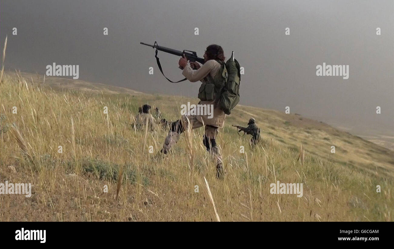 Islamic State fighters with the Storming Battalion attempt for the second time to capture Peshmerga Kurdish positions North of Mosul May 3, 2016 near Tesqopa, Iraq. The still image is captured from a propaganda video released by the Islamic State of Iraq and the Levant. Stock Photo