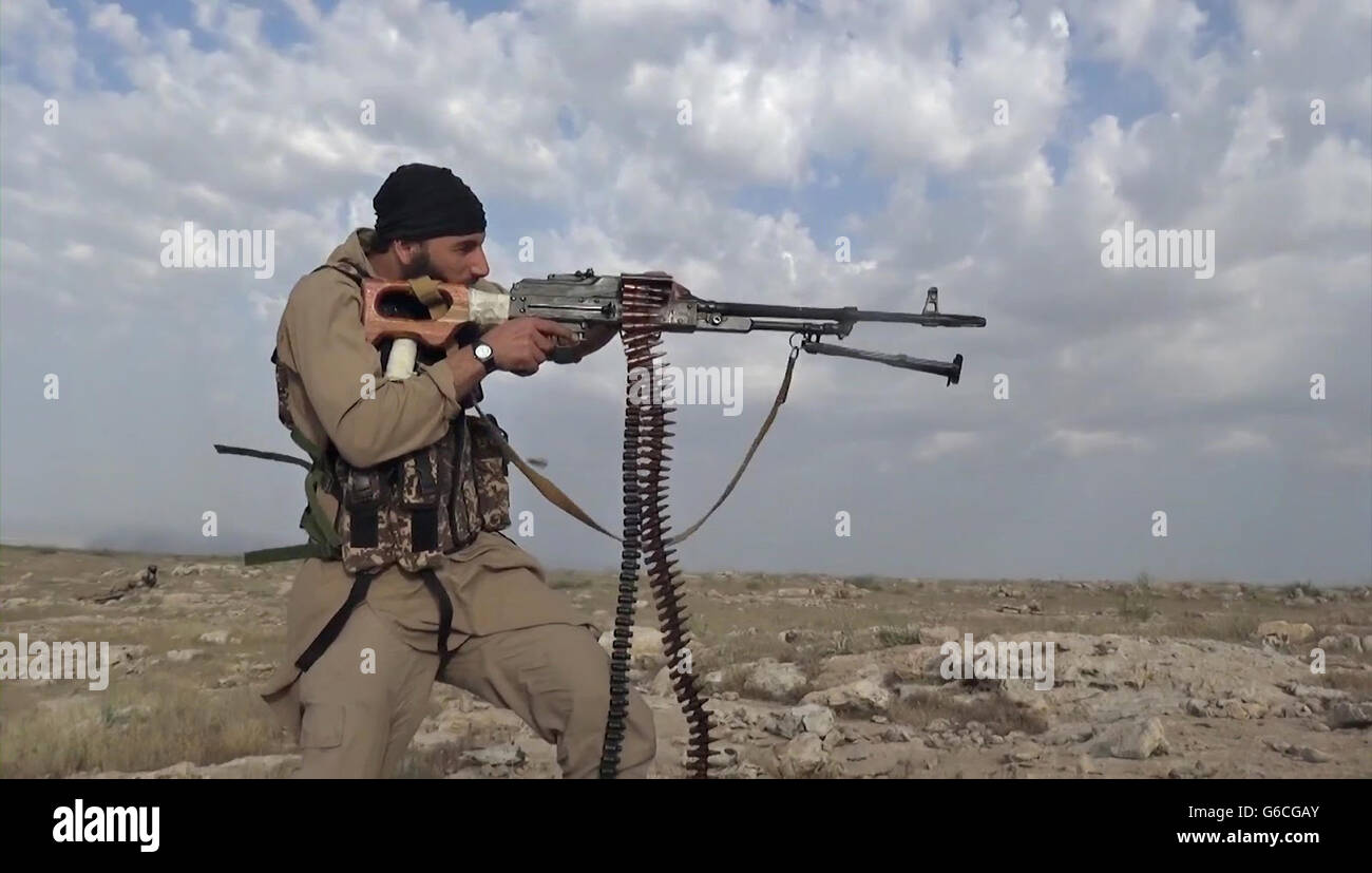 Islamic State fighters with the Storming Battalion attempt for the second time to capture Peshmerga Kurdish positions North of Mosul May 3, 2016 near Tesqopa, Iraq. The still image is captured from a propaganda video released by the Islamic State of Iraq and the Levant. Stock Photo