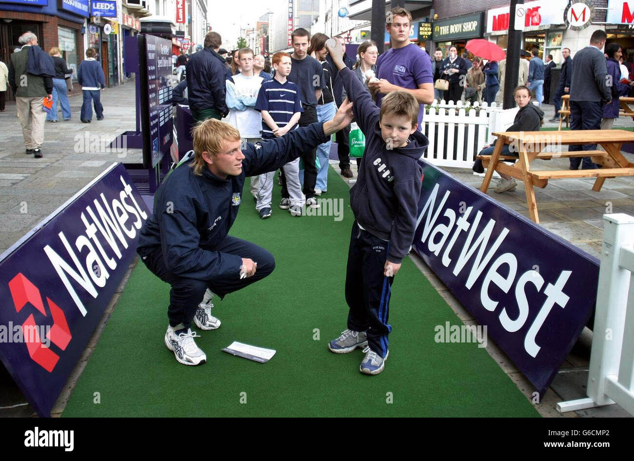 Durham cricketer Mark Davies gives seven-year-old Reece Morgan a few bowling tips, during the NatWest Interactive Roadshow in Newcastle. The youngster, from Pelaw, Gateshead, was there to see the cricketer take part in the NatWest Speed Challenge in the city's Haymarket. Stock Photo