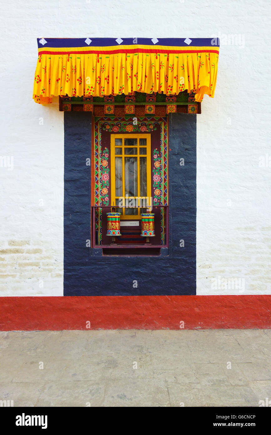 Beautiful colourful art decorations around two Tibetan prayer wheels at Pemayangtse Monastery, Pelling, Sikkim, India Stock Photo