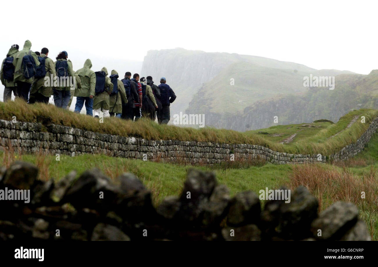 Walkers on Hadrian's Wall where, for the first time in 1600 years, hikers will be able to follow the entire length of the wall - 84 miles - along an unbroken path. * The Hadrian's Wall Path is part of a 6million investment by the Countryside Agency, and is expected to attract 20,000 people a year by 2006. Hadrian's Wall - a World Heritage Site - was built by the Romans from 122 AD as one of the most northerly frontiers of their empire. Stock Photo