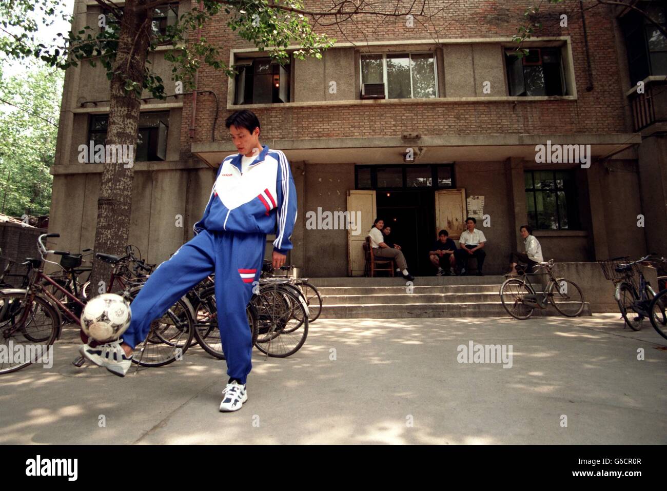 Chinese football star Fan Zhiyi signs his name for an inmate at